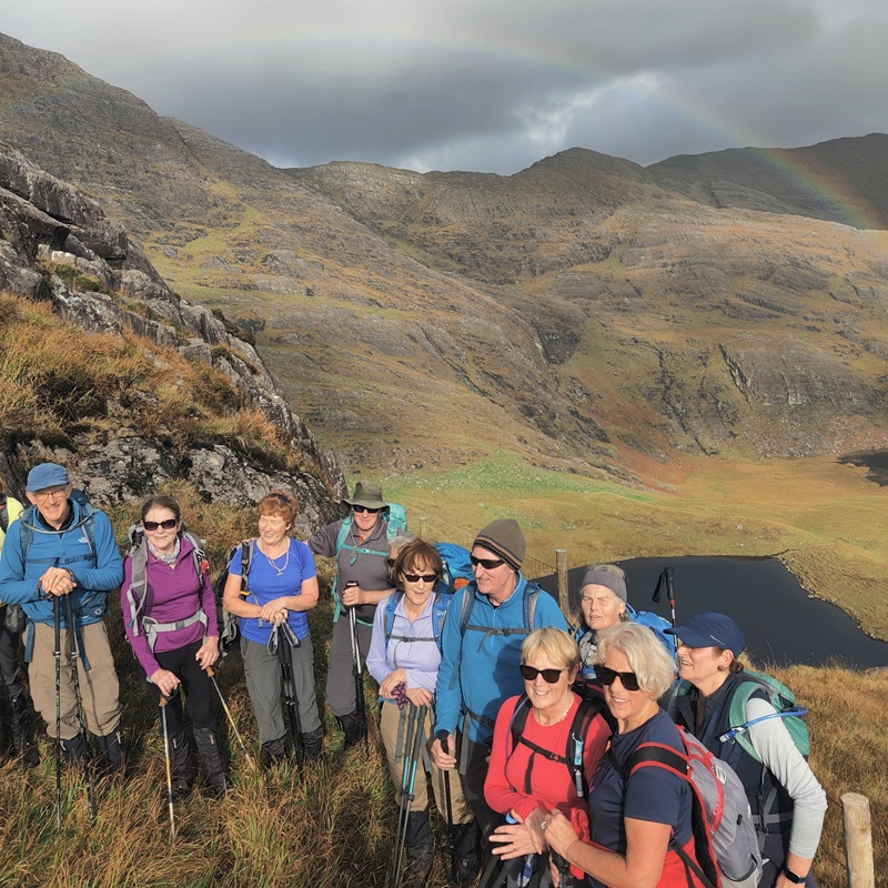 Rainbows and hillwalkers above Lough Coomeen